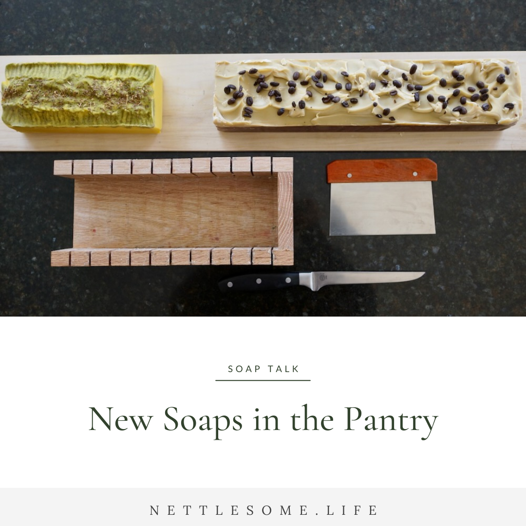 whole loaves of soap on a counter top with a cutting box and knives