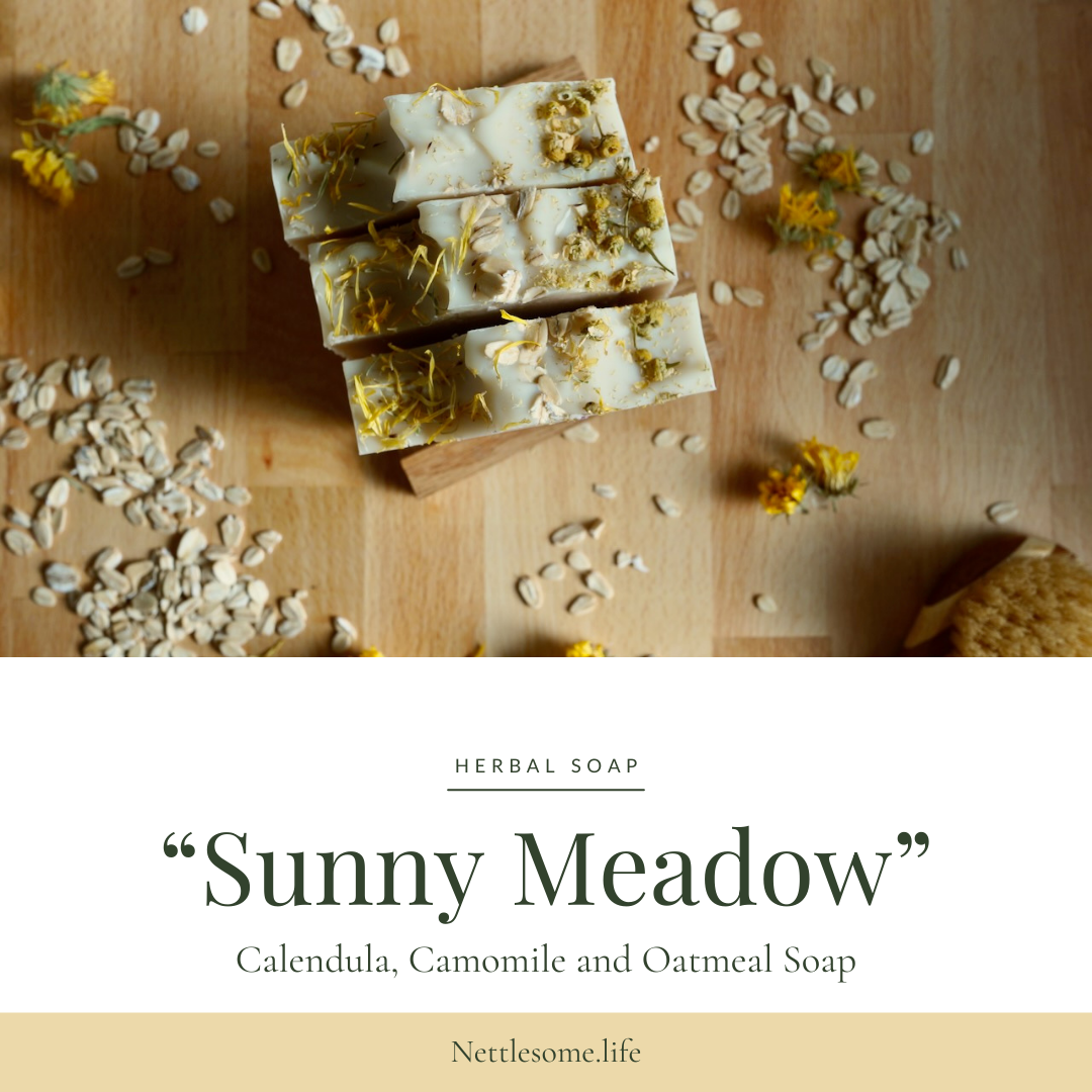 oatmeal soap surrounded by calendula and oat flakes on butcher block