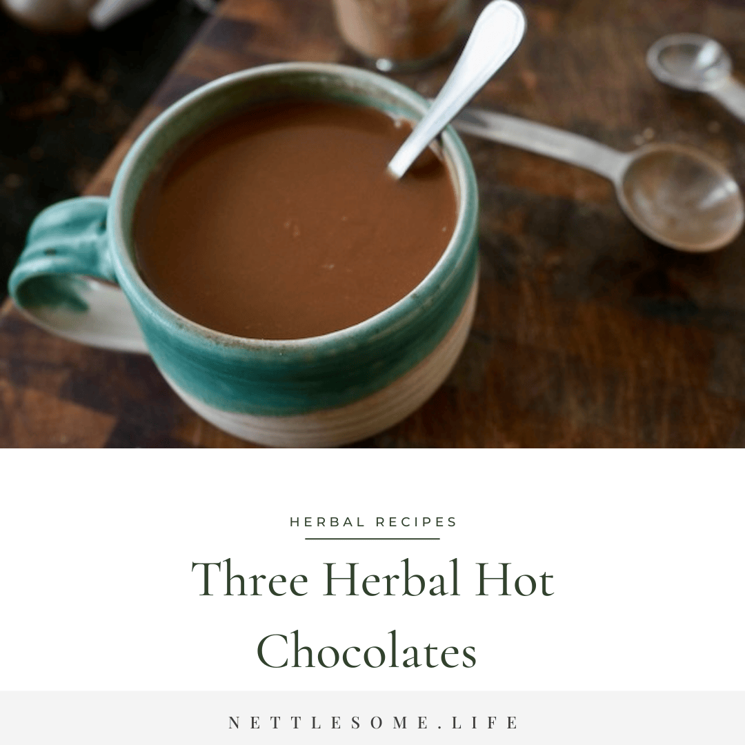 cup on hot chocolate  with a spoon in it on a wooden table with